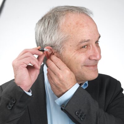 Man in suit with hearing aid
